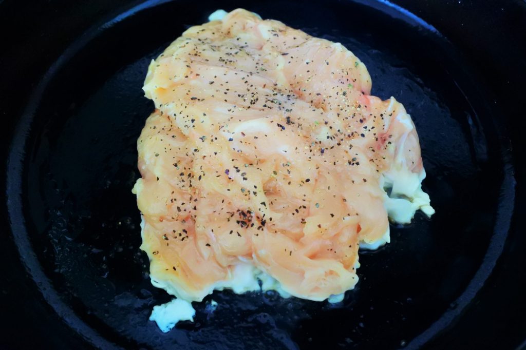 An overhead image of sliced pan seared chicken breast in a skillet