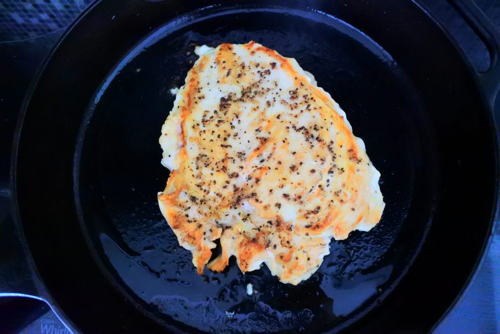 An overhead image of sliced pan seared chicken breast in a skillet