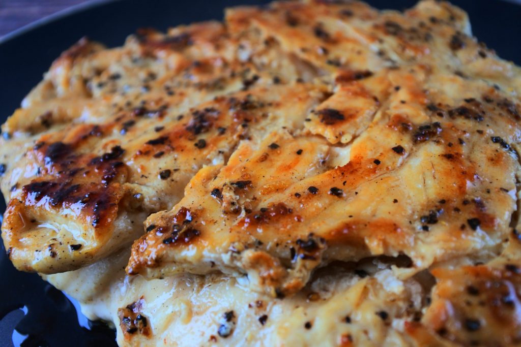 A close up image of sliced pan seared chicken breast