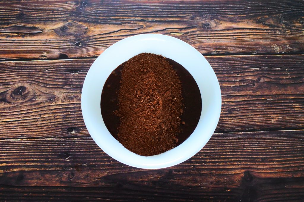 An overhead image of a bowl of unmixed brownie batter ingredients