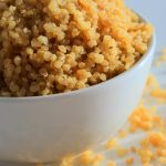 A vertical head on image of a bowl of fluffy quinoa