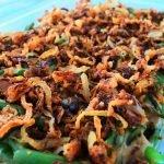 An angled image of crispy onions on a green bean casserole