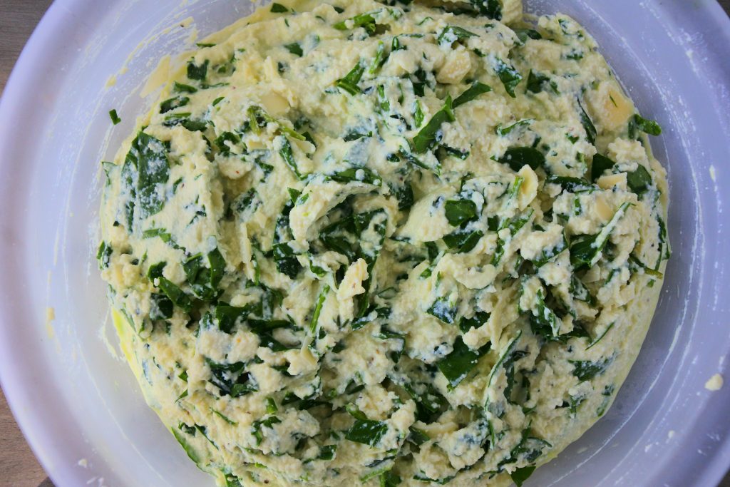 An overhead image of a bowl of a spinach and ricotta mixture
