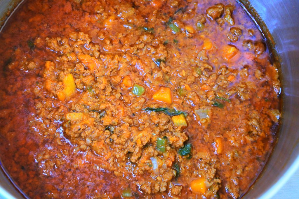 An overhead image of meat sauce in a pot