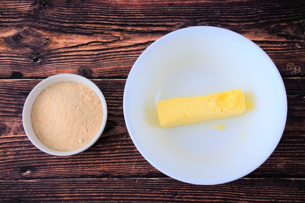 An overhead image of a bowl of butter and a bowl of blended sugar and potato starch