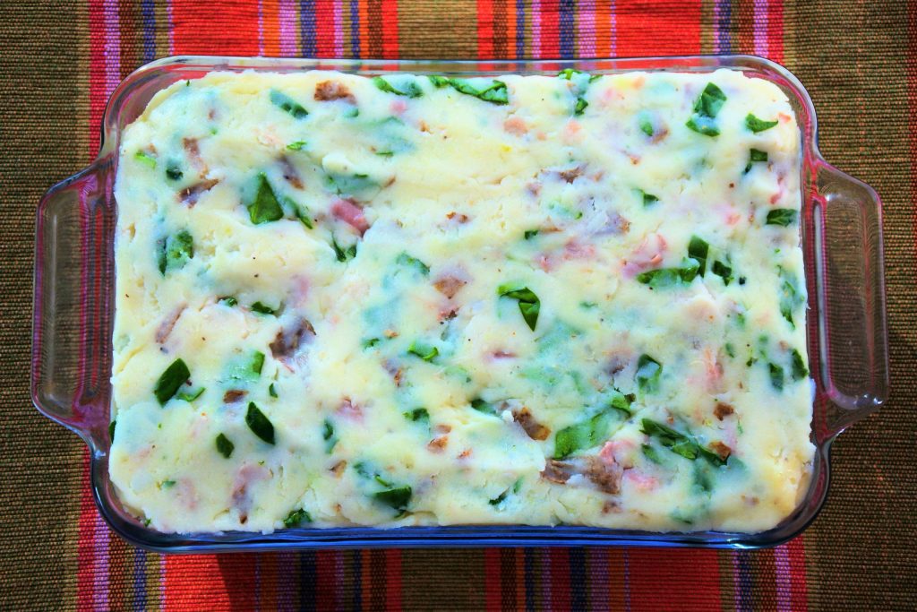 An overhead image of a next level mashed potatoes in a baking dish