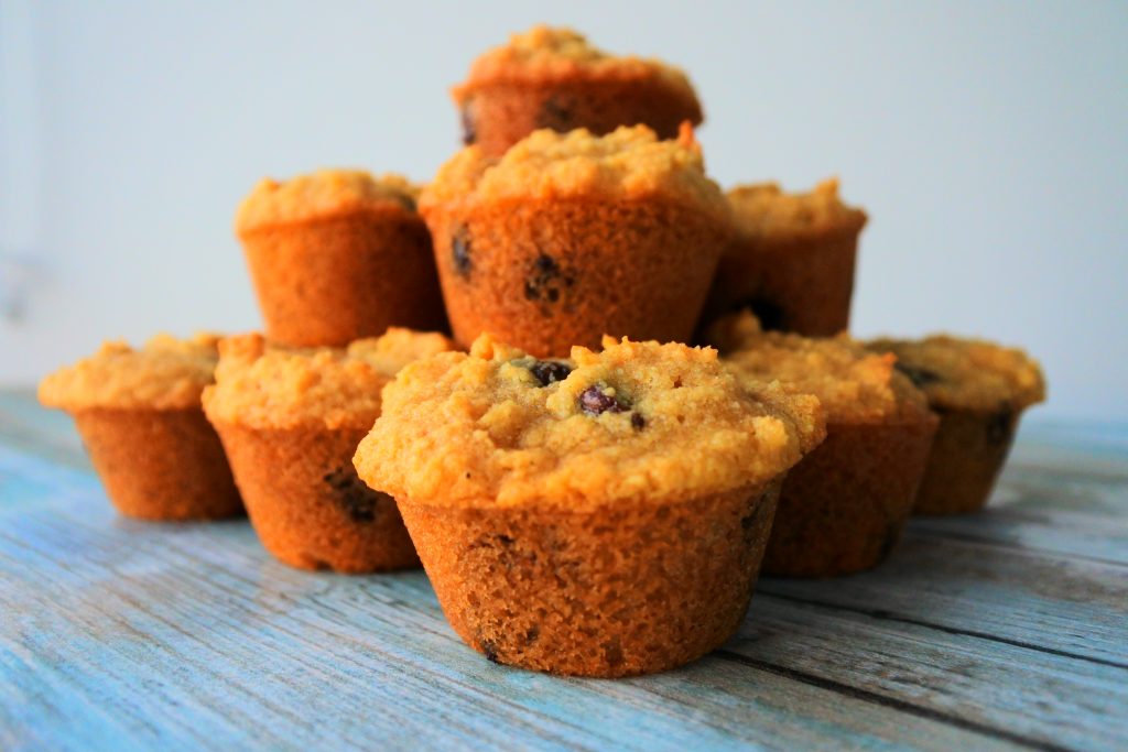 A close up image of a pyramid of chocolate chip mini muffins