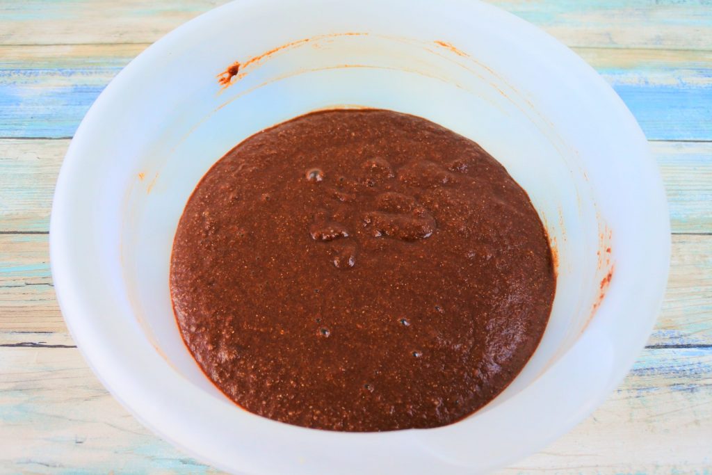 An angled image of a bowl of Gluten Free Double Chocolate Chip muffin batter