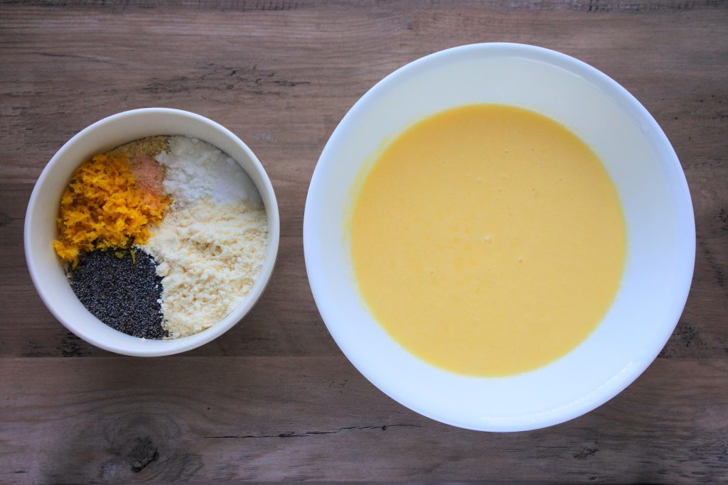 An overhead image of two bowls, one containing dry ingredients and the other containing blended wet ingredients
