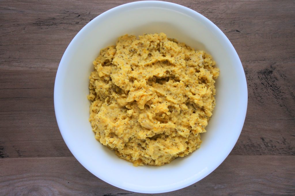 An overhead image of a bowl of lemon poppyseed muffin batter