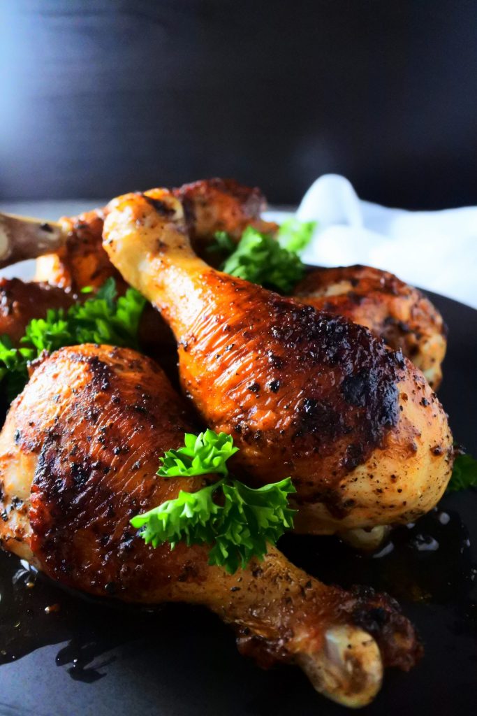 A close up image of a plate of pan fried chicken drumsticks