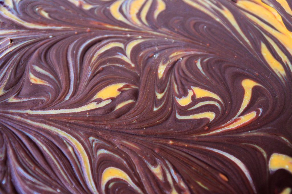 A close up image of dark chocolate swirled into peanut butter