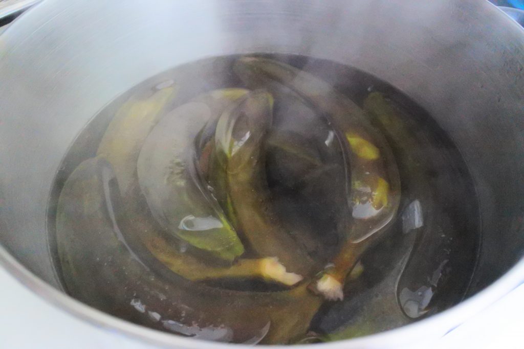 An angled image of a pot of boiled green bananas