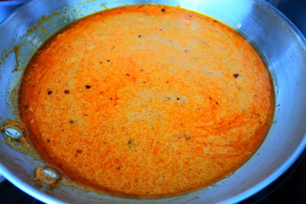 An overhead image of a pan of red thai curry