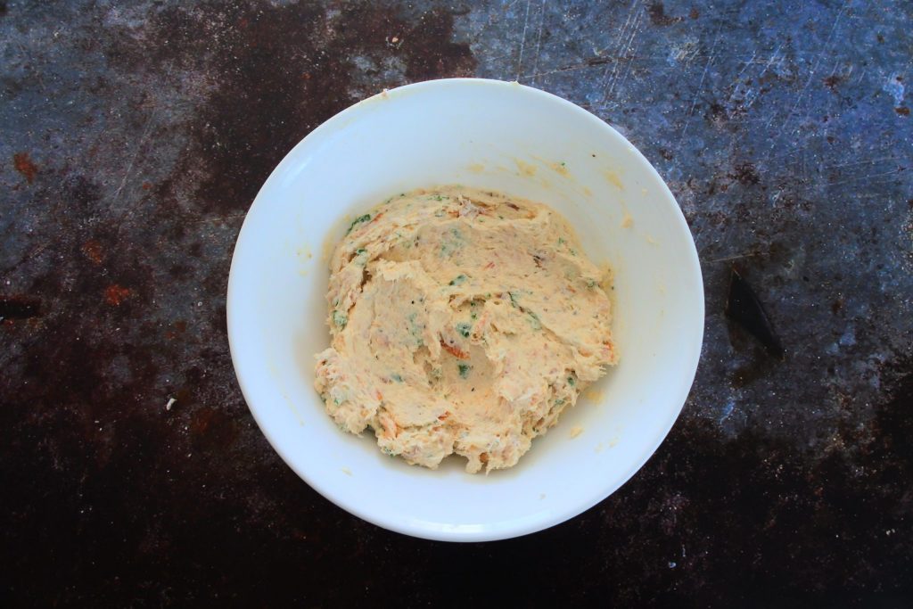 An overhead image of a bowl of mixed in smoked trout dip