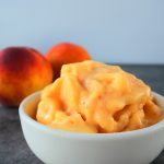 A close up image of a bowl of one ingredient peach sorbet
