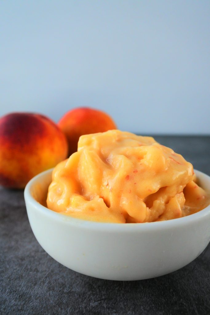 A close up image of a bowl of one ingredient peach sorbet