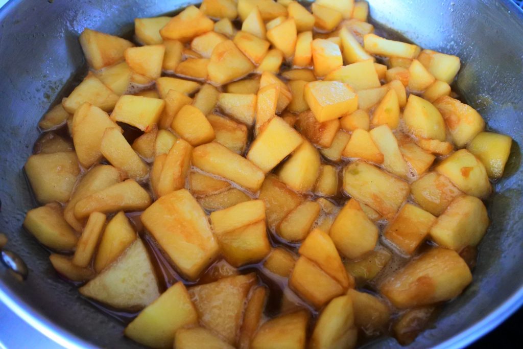 An overhead angled image of apple chunks in a skillet