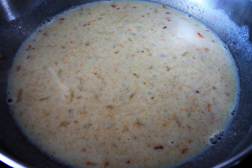 A close up image of a roux with milk in a pan