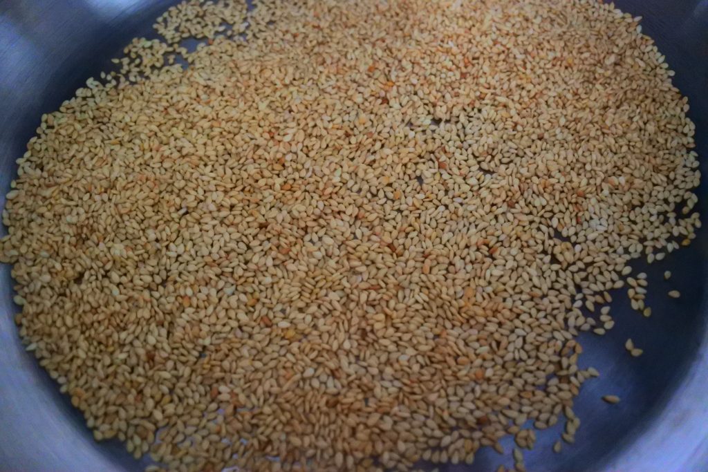 An overhead image of toasted sesame seeds in a skillet